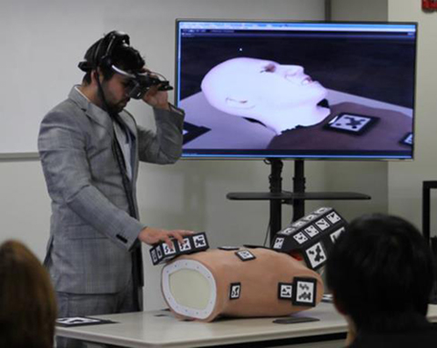 A UCF student from the winning team demonstrates the MREAL System to simulate the conditions of a medical emergency for training first responders (image credit: Canon).